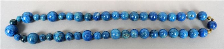 A lapis lazuli bead necklace The beads of varying sizes. Approximately 60 cms long. Overall good,