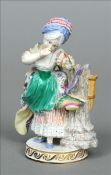 A late 19th century Meissen figurine Formed as a young lady holding an arrow; together with two