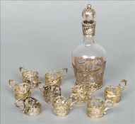 A Continental unmarked white metal mounted clear glass liqueur decanter Decorated with bands of