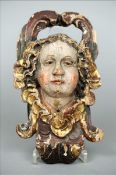 A 17th/18th century polychrome painted carved wooden wall mask The pierced scrolling top above the