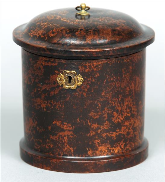 A 19th century Continental faux tortoiseshell tea caddy Of circular section, the hinged cover with