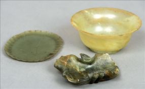 A small carved jade dish Centrally carved with a flowerhead; together with a jade bowl; and a leaf