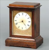 A small Victorian rosewood cased mantle clock The stepped rectangular case centred with a white dial