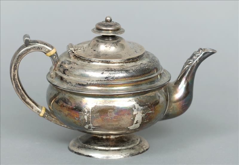A George I silver teapot, hallmarked Newcastle 1721, maker`s mark indistinct The finial mounted