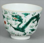 A Chinese porcelain tea bowl The exterior decorated with dragons chasing a flaming pearl within