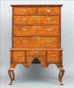 An 18th century and later walnut and burr elm chest on stand The moulded rectangular top above two
