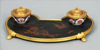 A late 19th century Japanese ormolu mounted lacquered inkstand The kidney shaped tray decorated with