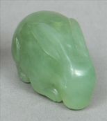An 18th century Chinese translucent green jade pendant Formed as a rabbit modelled on all fours,