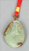 A Chinese carved green and russet jade pendant pebble Decorated with the figure of a sage opposing a