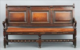 A late 17th/early 18th century oak three panelled settle The dentil moulded top rail above the three