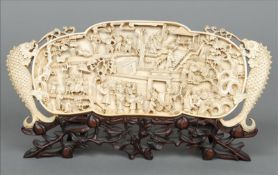 A 19th/20th century Chinese carved ivory plaque Worked with figures in various pursuits and