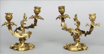 A pair of 19th century rococo style gilt bronze twin branch candelabra Each of organic scroll cast