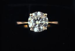 An 18 ct gold diamond solitaire ring The claw set stone approximately 2.11 carats; together with a