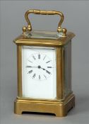 A late 19th century miniature brass cased carriage clock The white enamel dial with Roman