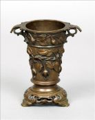 A 19th century Chinese bronze vase The foliate cast tapering cylindrical body issuing twin pierced
