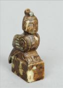 A Chinese carved mottled green jade seal Surmounted with the figure of a harpy. 8.5 cms high.