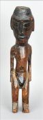A 19th/20thcentury Easter Island carved wood figure Modelled standing. 41.5 cms high. Generally in