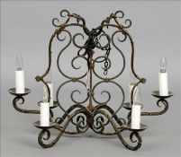 An early 20th century wrought iron chandelier The six branch light of scrolling form with green