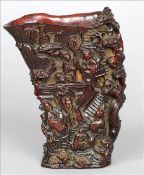 A Chinese carved horn libation cup Carved with various figures in landscapes, four character seal
