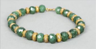 A string of faceted jade Mughal beads Each interspersed by a thread work bead. 40 cms long. Some