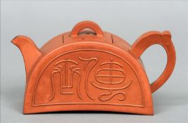 A Chinese Yixing pottery teapot and cover Of semi-circular form, decorated with archaistic