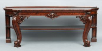An early 19th century mahogany serving table The shaped rectangular top above a deep frieze with a