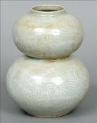 A 19th century Oriental grey/green glazed double gourd vase With white slip decoration and signed to