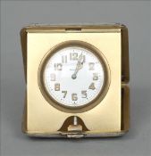 A George V silver cased travelling clock, hallmarked London 1921, maker`s mark indistinct The hinged