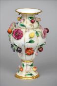 A Continental florally encrusted porcelain vase The main ground of basket weave form, the