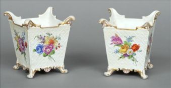 A pair of 19th century Berlin cache pot Of canted basket moulded form, painted with flowers with