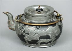 An early 20th century white metal mounted Chinese teapot With twin brass loop handles and the