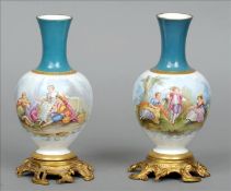 A pair of Continental Sevres style ormolu mounted porcelain vases Each painted with various