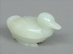 A Chinese pale celadon jade box and cover modelled as a duck 9 cms wide. Overall good, some