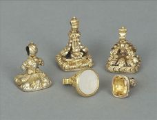 Five 19th century yellow metal mounted hardstone seals Each with elaborately cast scroll mounts