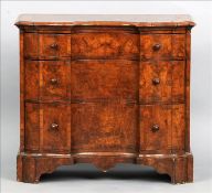 An 18th century style walnut chest of drawers The crossbanded concave serpentine shaped top above