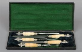A cased five piece silver plate mounted carved bone handled carving set Comprising: two forks, two