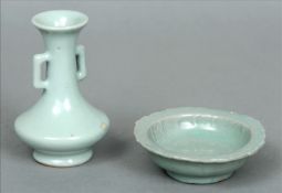 A small Chinese Ming Dynasty porcelain celadon glazed twin handled vase and similarly glazed small