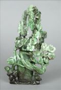 A Chinese carved spinach green jade vase and cover Formed as birds amongst foliage. 23 cms high.