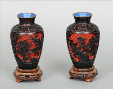 A pair of Chinese cinnabar lacquered vases Each of squat bulbous form decorated with flowers amongst