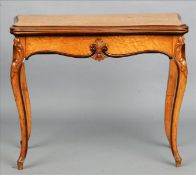 A late 19th century burr maple card table The hinged serpentine top enclosing a baize lined