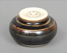 A Northern Song dynasty type black glazed small jar Of squat bulbous form with a later ivory