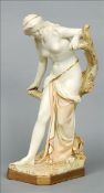 A large Royal Worcester Art Nouveau figurine Formed as a semi-nude lady perched beside a tree, the