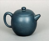 A Chinese Yixing pottery teapot and cover With allover blue/grey glaze, impressed seal mark to