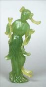A Chinese jade figure Formed as a girl in flowing robes holding two cups. 21 cms high. Some