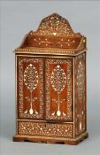 A 19th century Anglo-Indian ivory inlaid padouk stationery cabinet The arched pediment inlaid with