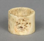 A late 19th century Chinese carved bone archers ring Decorated with two figural carved roundels