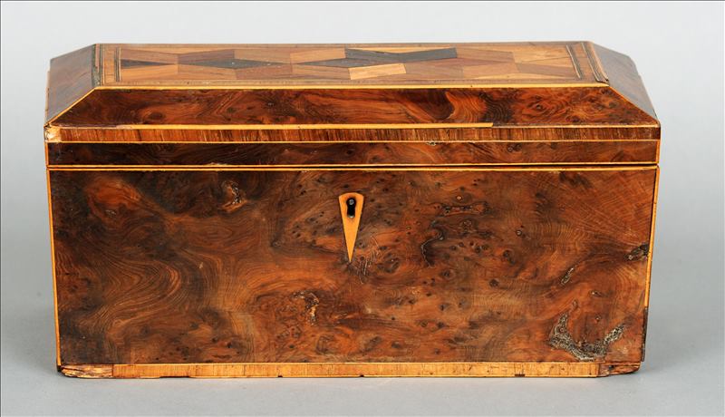 A 19th century parquetry inlaid yewwood tea caddy The hinged lid centred with a panel of geometric