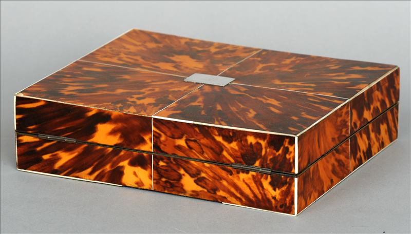 A 19th century tortoiseshell covered shallow box The quarter veneered hinged cover inset with a