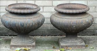 A pair of 19th century cast iron garden urns Each of lobed baluster form. Each 50 cms high. (2)