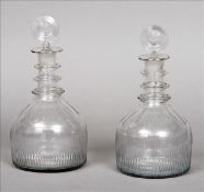 A pair of George III cut glass mallet shaped decanters The circular concave stoppers above the